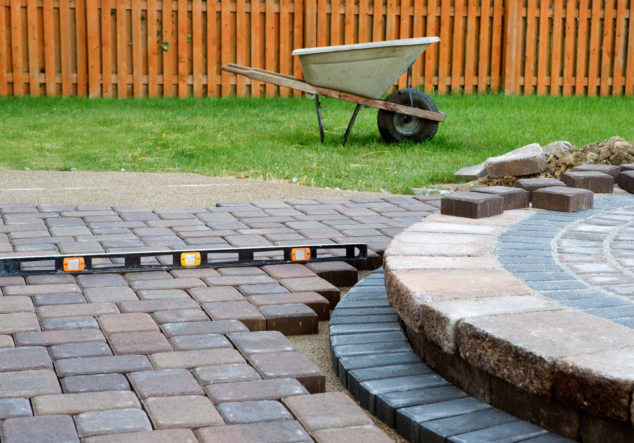 Patio Work. Wehn building a patio prepare to use level and barrel constantly, patio island have polymeric sand layed and job completion almost done when final pavers cut and placed